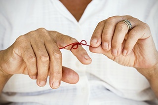 Menopausal woman with string tied on her finger